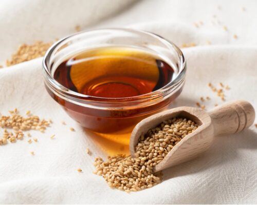 Bowl of brown oil with sesame seeds